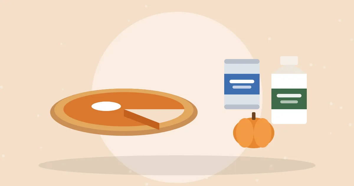 Pumpkin pie with a slice cut out next to a carton of heavy cream, a can of milk and a small pumpkin